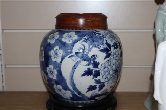 Two Chinese blue and white jars and covers and a pair of hardwood stands